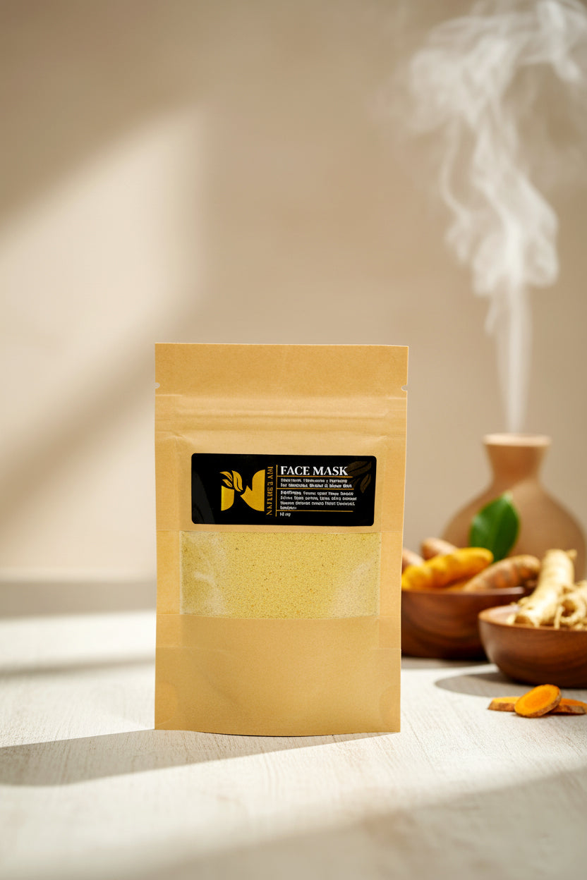 A stand-up pouch of face mask powder stands on a tabletop in warm sunlight, with a black label reading FACE MASK. A small vase and bowls with dried ingredients sit blurred in the background, and steam rises from the vessel.